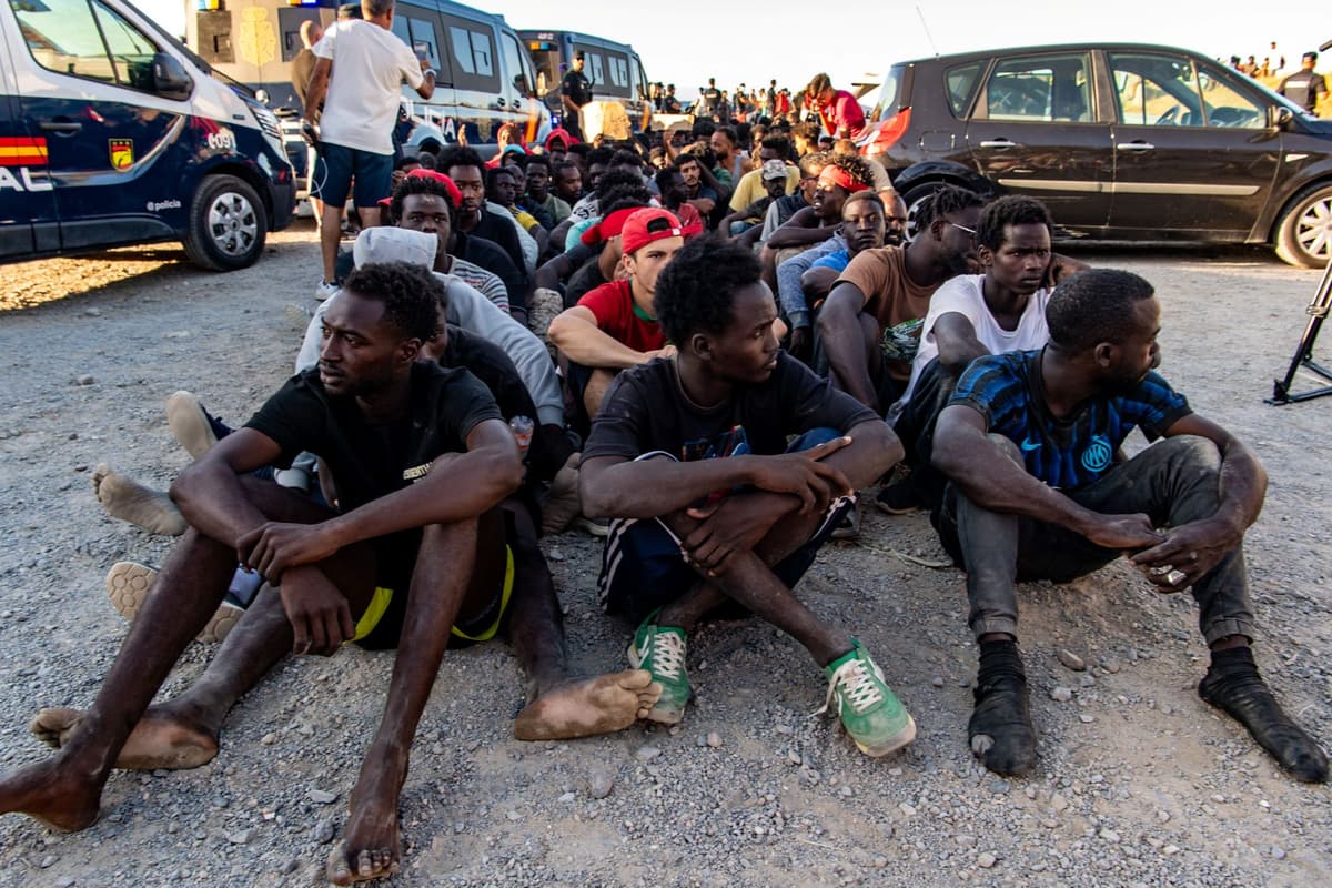 Migranti, ktorí prekročili hranicu z Maroka do Španielska, čakajú v rade na rozdávanie jedla na pláži v španielskej enkláve Ceuta, v pondelok 3. augusta 2026. Foto: TASR/AP